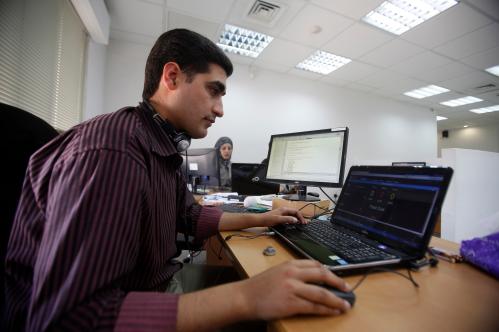 Employees work on computers at Exalt Technologies, a company which deals in research and development outsourcing from Cisco and French-American group Lucent-Alcatel, in the West Bank city of Ramallah