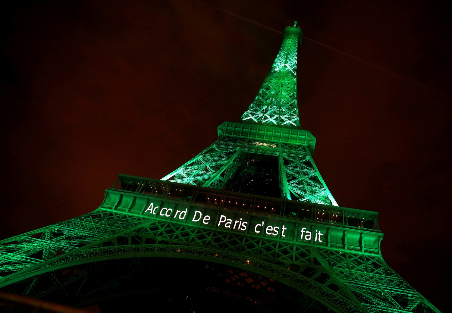 The Eiffel tower is illuminated in green with the words "Paris Agreement is Done", to celebrate the Paris U.N. COP21 Climate Change agreement in Paris, France, November 4, 2016. REUTERS/Jacky Naegelen/File Photo - RTX2SSYI