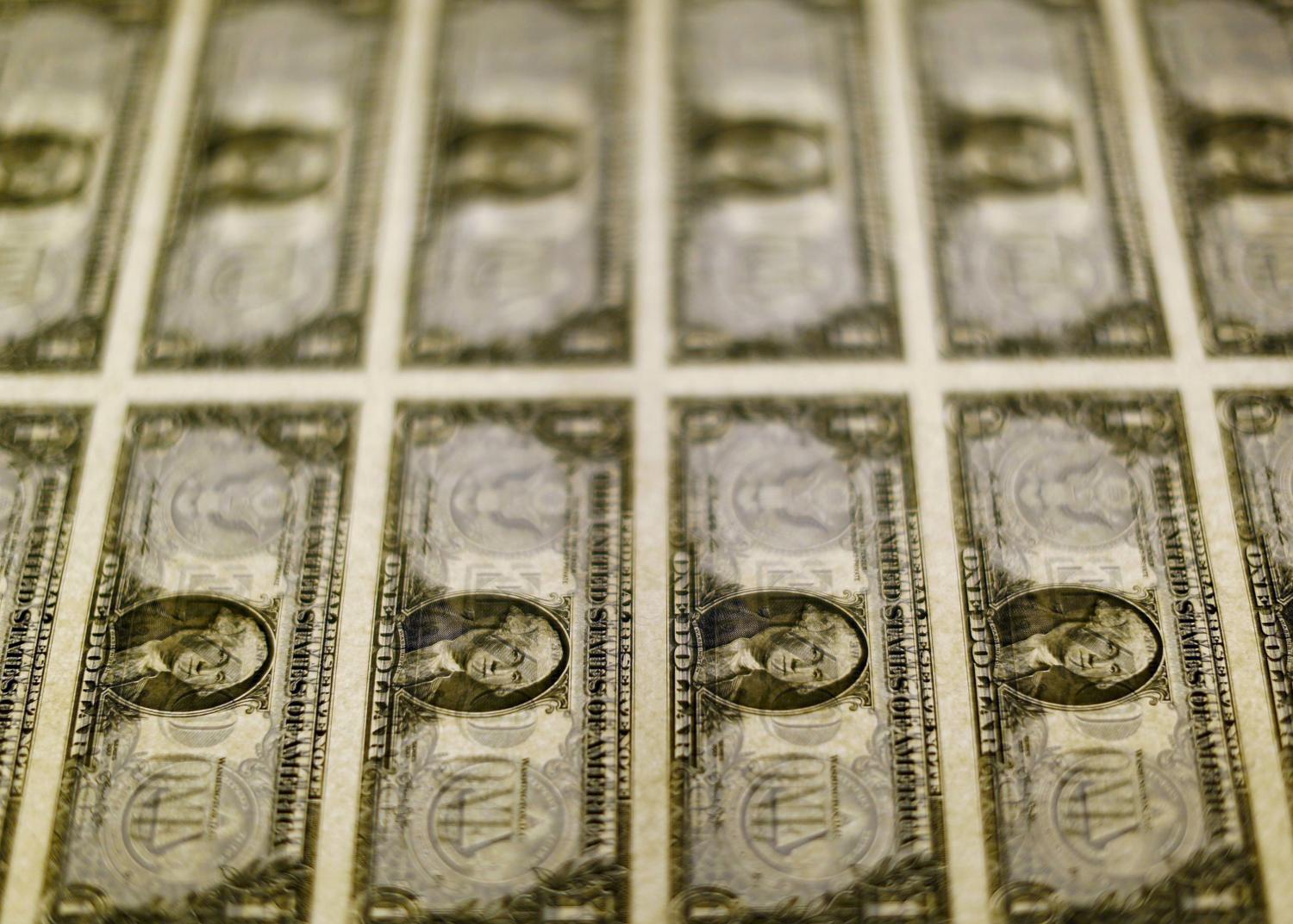 United States one dollar bills are seen on a light table at the Bureau of Engraving and Printing.