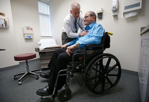 A doctor checks on one of his patients.