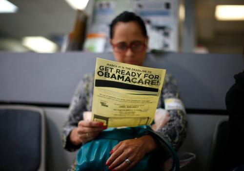 A woman reads a leaflet on Obamacare