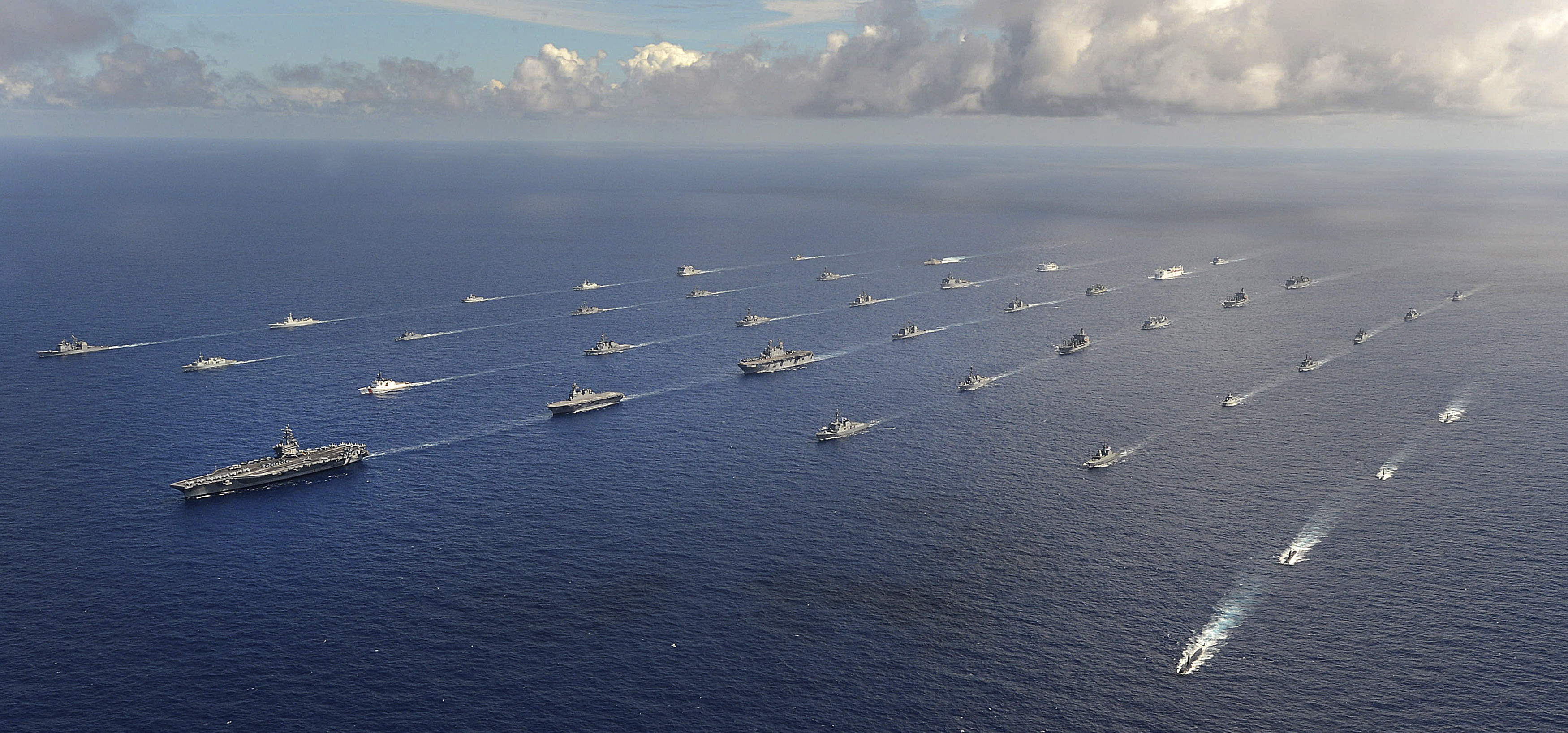 More than 40 ships and submarines representing 15 international partner nations travel in formation in the Pacific Ocean during the Rim of the Pacific (RIMPAC) 2014 exercise in this U.S. Navy photo taken July 25, 2014, and released July 31, 2014.  RIMPAC is a U.S. Pacific Fleet-hosted biennial multinational maritime exercise.  REUTERS/U.S. Navy/Mass Communication Specialist 1st Class Shannon E. Renfroe/Handout  (UNITED STATES - Tags: MILITARY POLITICS) THIS IMAGE HAS BEEN SUPPLIED BY A THIRD PARTY. IT IS DISTRIBUTED, EXACTLY AS RECEIVED BY REUTERS, AS A SERVICE TO CLIENTS. FOR EDITORIAL USE ONLY. NOT FOR SALE FOR MARKETING OR ADVERTISING CAMPAIGNS - RTR40UA4