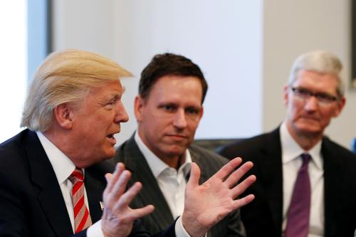 U.S. President-elect Donald Trump speaks as PayPal co-founder and Facebook board member Peter Thiel (C) and Apple Inc CEO Tim Cook look on during a meeting with technology leaders at Trump Tower in New York U.S., December 14, 2016. REUTERS/Shannon Stapleton - RTX2V25H