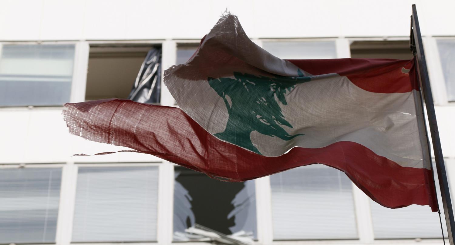 Lebanon's flag flies in front of damaged windows at the Starco building in front of the site of a bomb blast, which killed Lebanon's former Finance Minister Mohamad Chatah, in downtown Beirut December 28, 2013. Chatah, who opposed Syrian President Bashar al-Assad, was killed in a massive bomb blast on Friday which one of his political allies blamed on the Shi'ite Hezbollah militia. Former prime minister Saad al-Hariri accused Hezbollah of involvement in the killing of Chatah, his 62-year-old political adviser, saying it was "a new message of terrorism". REUTERS/Jamal Saidi (LEBANON - Tags: CIVIL UNREST POLITICS) - RTX16VMI