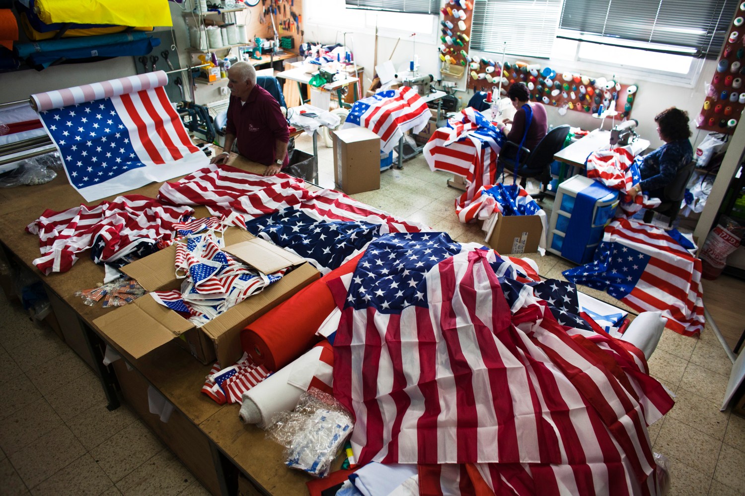 Workers at a factory in Kfar Saba near Tel Aviv sew U.S. flags that were ordered ahead of President Barack Obama's visit to Israel March 12, 2013. It was the most work the factory has had since Egyptian President Anwar Sadat visited Israel in 1977, owner Avi Marom said on Tuesday. The White House has yet to officially announce the dates for the trip, but Israeli news media have reported that Obama will arrive in Israel on March 20. REUTERS/Nir Elias (ISRAEL - Tags: POLITICS) - RTR3EVOE