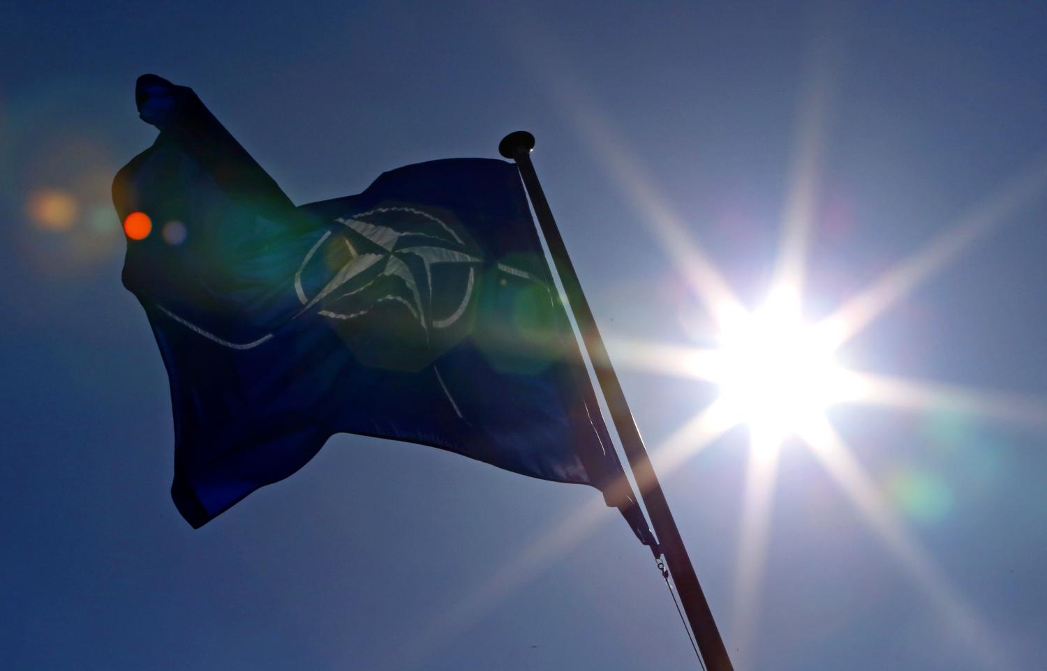 A NATO flag flies at the Alliance headquarters in Brussels during a NATO ambassadors meeting on the situation in Ukraine and the Crimea region, March 2, 2014. Russia is threatening peace in European via its military actions in Ukraine and must immediately de-escalate tensions, Rasmussen said on Sunday. REUTERS/Yves Herman (BELGIUM - Tags: POLITICS CONFLICT MILITARY) - RTR3FWFO