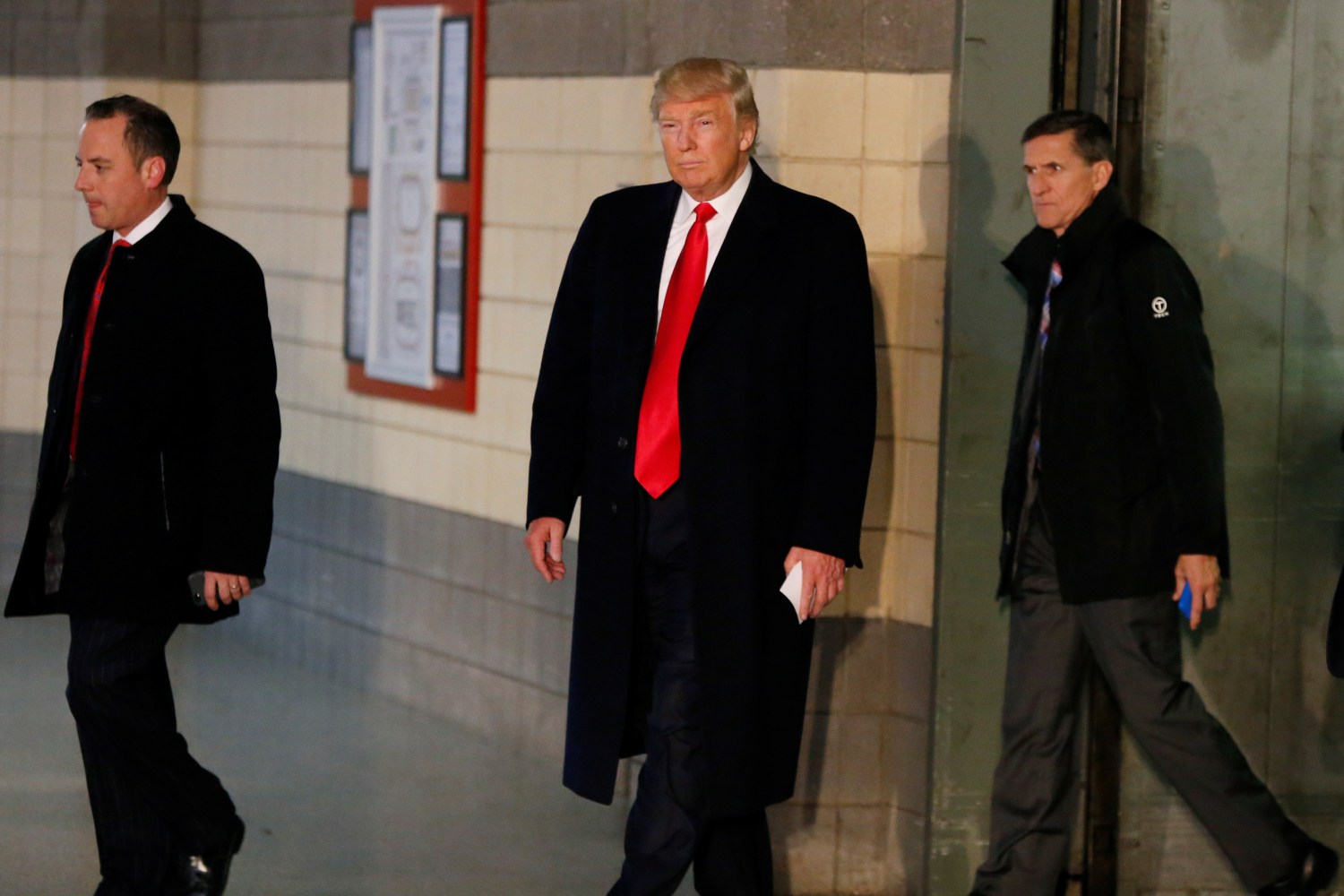 U.S. President-elect Donald Trump leaves an elevator with Reince Priebus (L) and retired U.S. Army Lieutenant General Michael Flynn before speaking with the media about meeting with families of the victims of the November 28 attacks at Ohio State University, in The Jerome Schottenstein Center in Columbus, Ohio, U.S., December 8, 2016. REUTERS/Shannon Stapleton - RTSVBCK