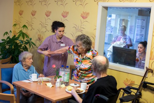 Alba Gil Quiros (2nd L) from the Spanish island of Tenerife assists a resident