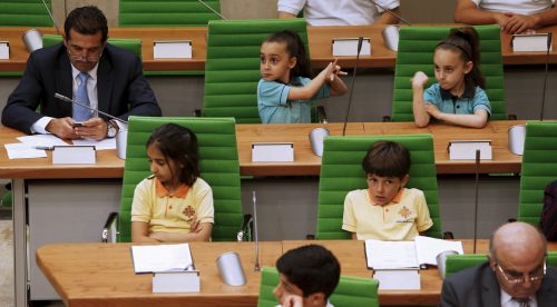 Schoolchildren take part in a debate in the national parliament chamber at Parliament House in Valletta