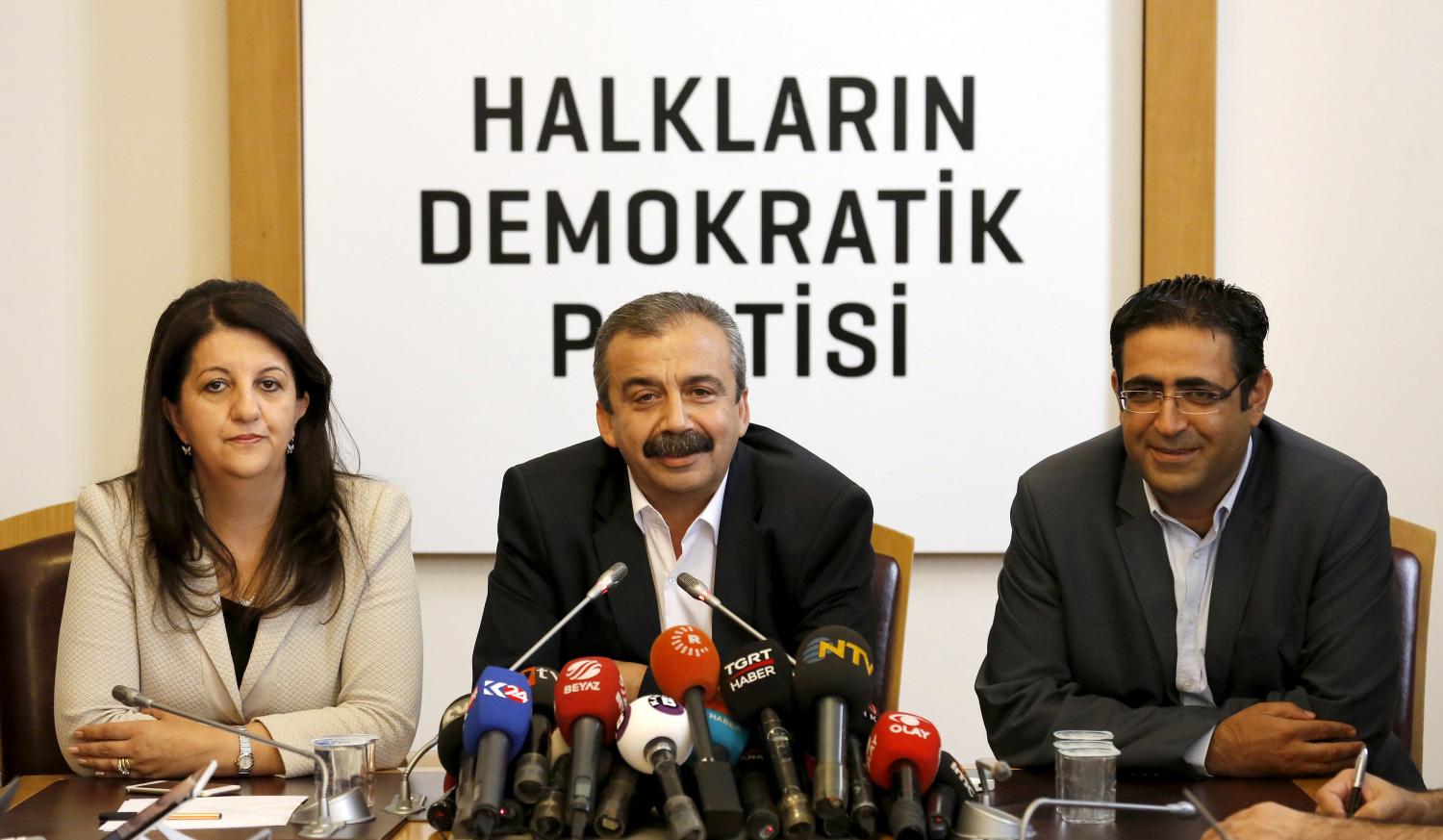 Pro-Kurdish politicians of Peoples' Democratic Party (HDP) Sirri Sureyya Onder (C), Pervin Buldan (L) and Idris Baluken attend a news conference in Ankara, Turkey, June 12, 2015. REUTERS/Umit Bektas/File Photo