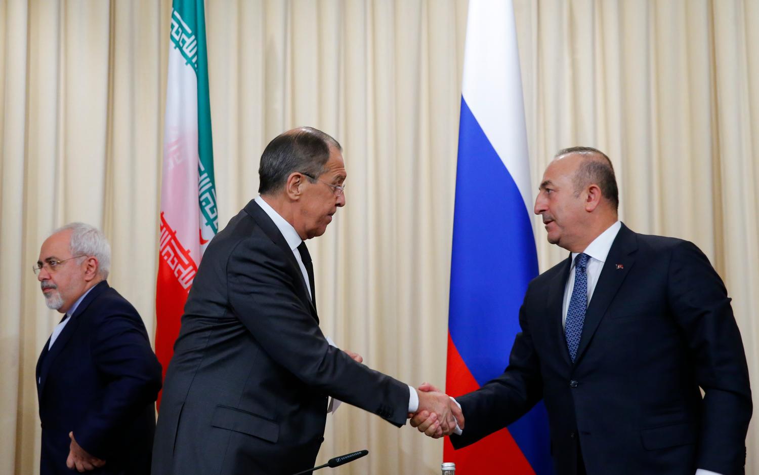 Foreign ministers, Sergei Lavrov (C) of Russia, Mevlut Cavusoglu (R) of Turkey and Mohammad Javad Zarif of Iran, leave after a news conference in Moscow, Russia, December 20, 2016. REUTERS/Maxim Shemetov