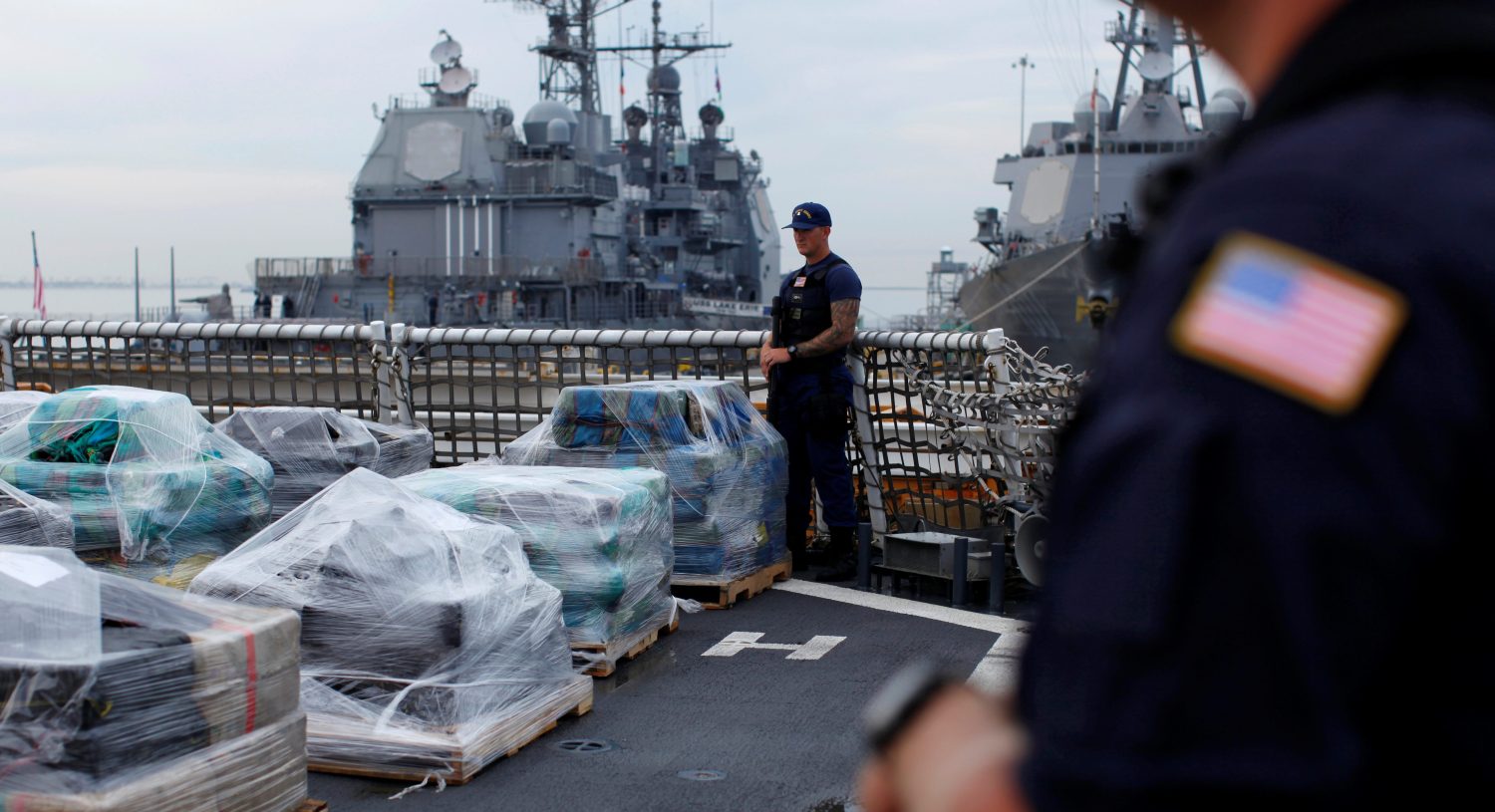 Armed U.S. Coast Guardsmen aboard the Coast Guard Cutter Waesche stand watch as more than 39,000 pounds of seized cocaine is offloaded at Naval Base San Diego, California, U.S., October 27, 2016. REUTERS/Mike Blake - RTX2QRU3
