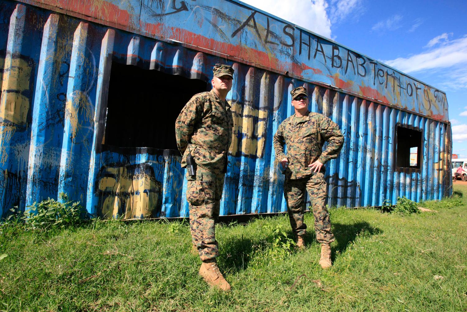 U.S. marines watch as members of the Uganda army undergo training in combat operation skills at a military training school in Singo, 78km (46 miles) south of capital Kampala, April 30, 2012, in preparation for their deployment to African Union Mission in Somalia (AMISOM). REUTERS/James Akena (UGANDA - Tags: POLITICS MILITARY) - RTR31F2U