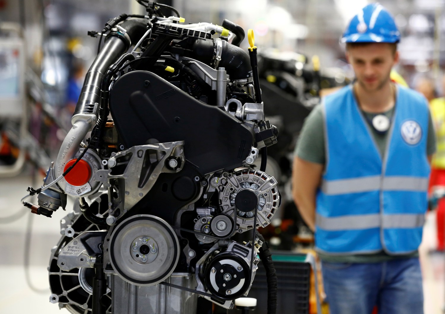 Workers work on a new Volkswagen Crafter diesel engine