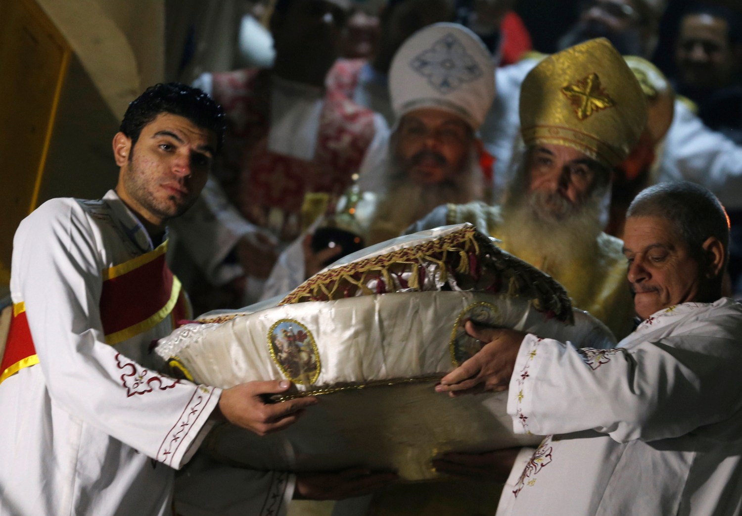 Coptic priests pray during Egypt's Coptic Christmas eve mass in a church of the Samaan el-Kharaz Monastery in the Mokattam Mountain area of Cairo, Egypt January 6, 2017. REUTERS/Amr Abdallah Dalsh