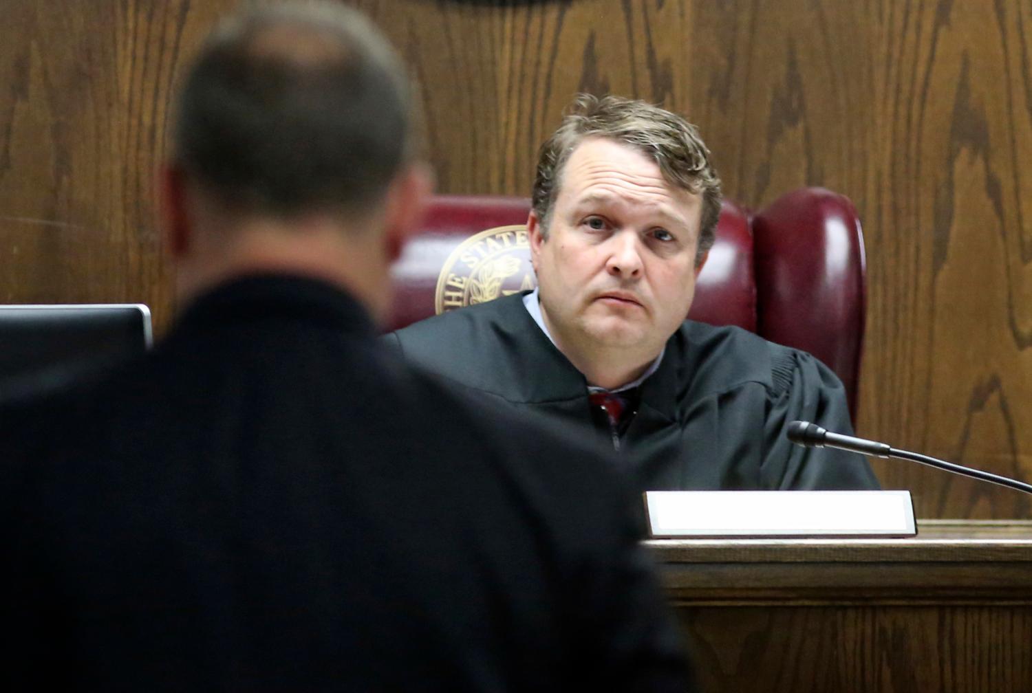 A judge listens to a lawyer.