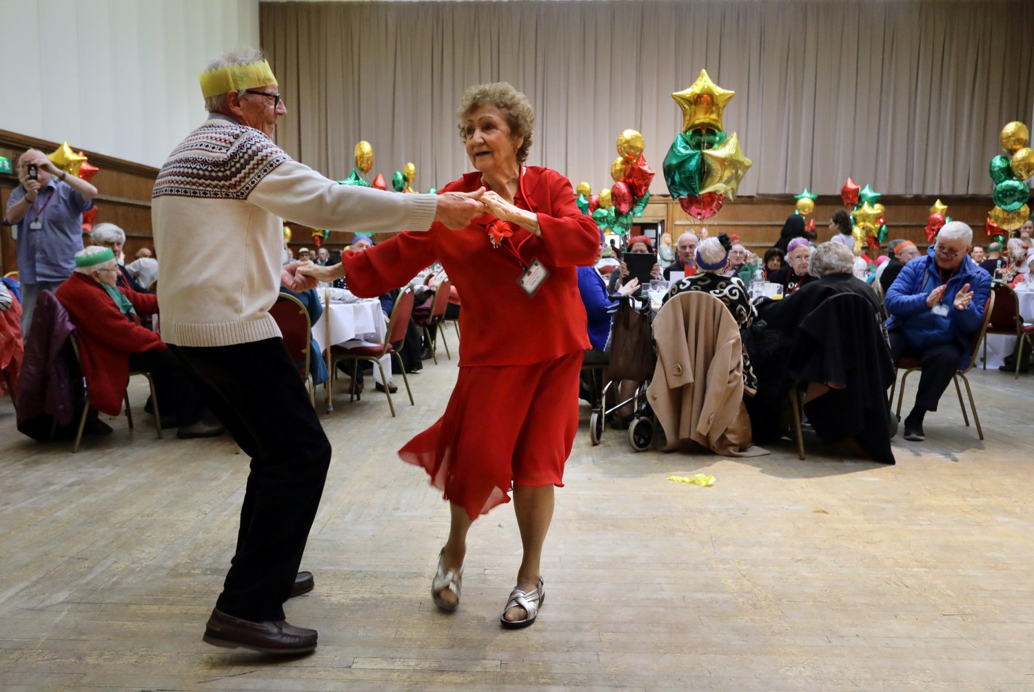 Anita Monk and her neighbour John Everett dance during a Christmas Dinner event for older people.