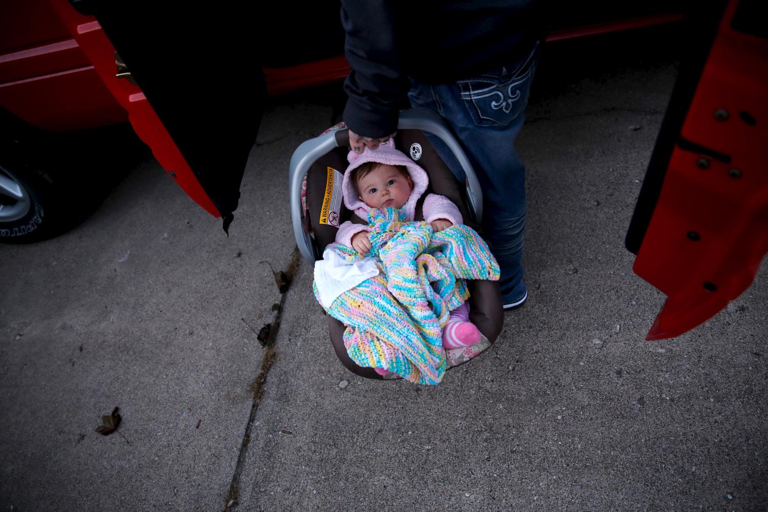 Donnie Gooding puts his baby Kennedy Gooding in his truck before going to dinner in Barboursville, West Virginia, October 18, 2015.