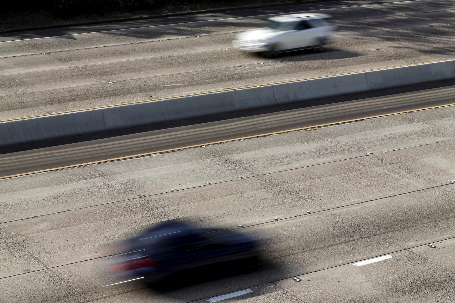 Cars travel on roads lacking painted freeway lane markers on Interstate highway 5 in San Diego, California February 10, 2016.