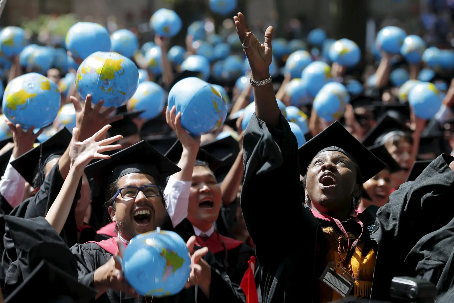 Olufunke Michaels (R) and her classmates celebrate after receiving their degrees from the John F. Kennedy School of Government during the 364th Commencement Exercises at Harvard University in Cambridge, Massachusetts May 28, 2015.