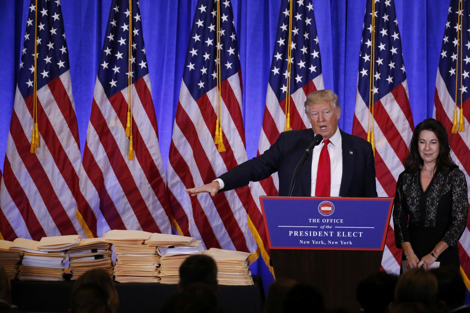 U.S. President-elect Donald Trump references a pile of papers as he speaks during a news conference in the lobby of Trump Tower in Manhattan, New York City, U.S., January 11, 2017. REUTERS/Lucas Jackson - RTX2YJ2P