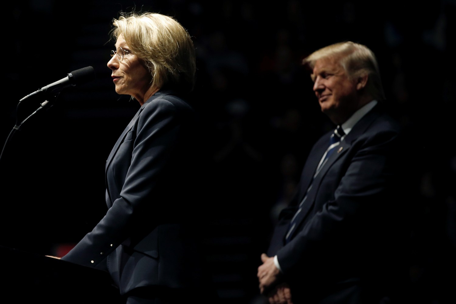 U.S. President-elect Donald Trump looks on as his choice for U.S. Education Secretary Betsy DeVos speaks at a "Thank You USA" tour rally in Grand Rapids, Michigan, U.S. December 9, 2016. REUTERS/Mike Segar - RTX2UD61
