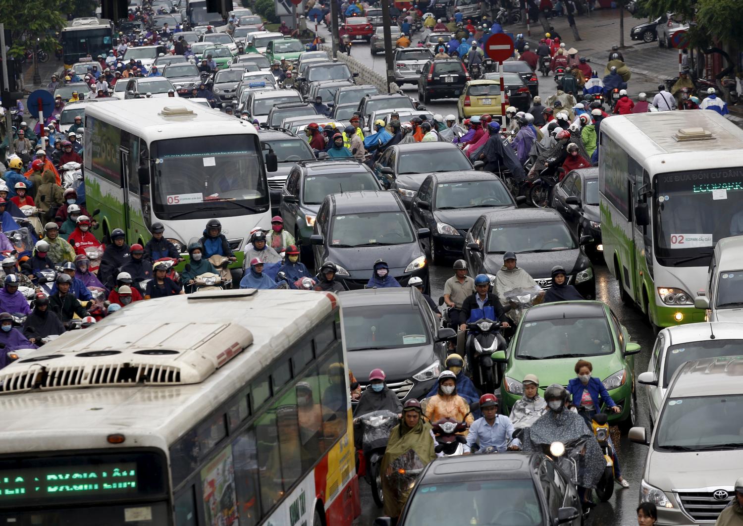 Commuters are seen during rush hour on a street in Hanoi, Vietnam