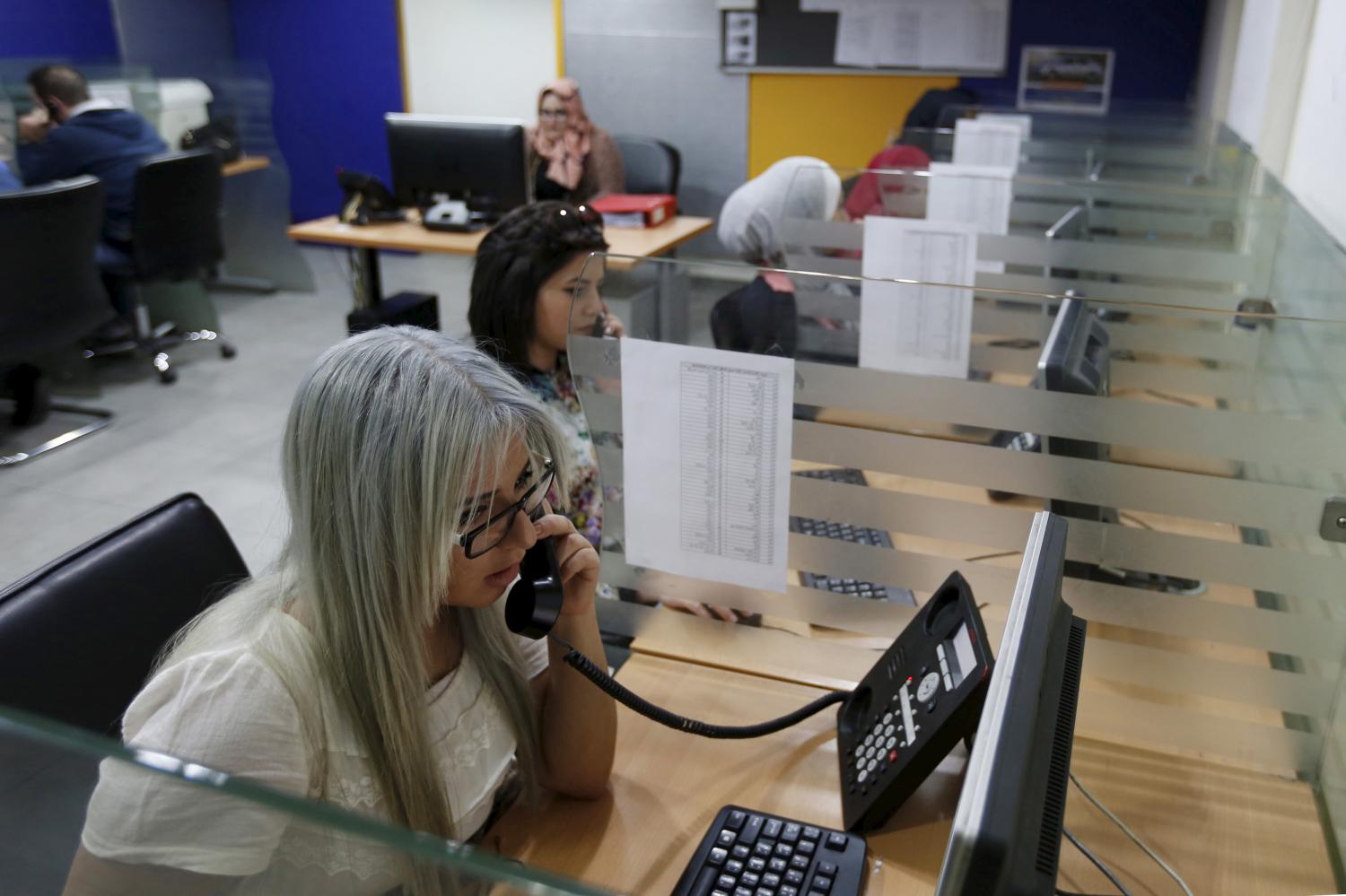 Call centre workers receive calls from female customers for taxi booking jobs at Noor Jordan for Transport  Taxi Moumayaz (Special Taxi) in Amman, Jordan, March 24, 2016. The Jordanian taxi company has launched a new service run only for women, exclusively by women, with 10 women taxi drivers for the first time in Jordan picking up only female passengers and families. The company chairman Abu al-Haj said they plan to hire another 10 women as drivers, and possibly more if the service expands. Picture taken March 24, 2016. REUTERS/Muhammad Hamed