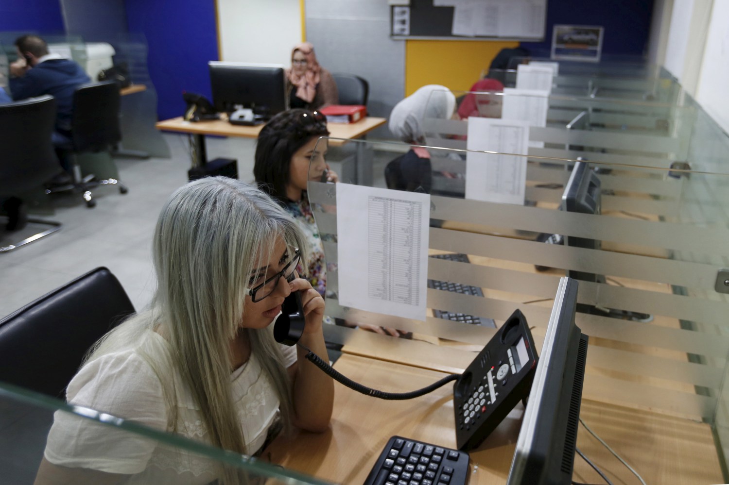 Call centre workers receive calls from female customers for taxi booking jobs at Noor Jordan for Transport  Taxi Moumayaz (Special Taxi) in Amman, Jordan, March 24, 2016. The Jordanian taxi company has launched a new service run only for women, exclusively by women, with 10 women taxi drivers for the first time in Jordan picking up only female passengers and families. The company chairman Abu al-Haj said they plan to hire another 10 women as drivers, and possibly more if the service expands. Picture taken March 24, 2016. REUTERS/Muhammad Hamed