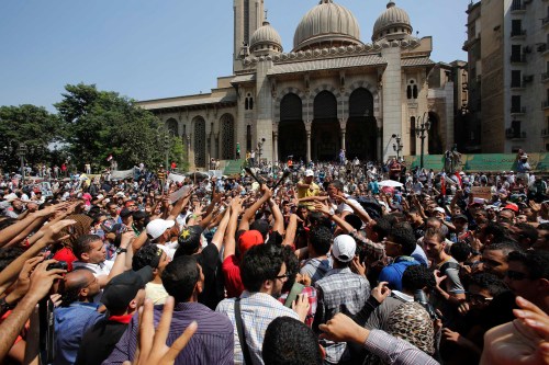 Supporters of deposed Egyptian President Mohamed Mursi shout slogans during a protest outside Al-Fath Mosque in Ramses Square, in Cairo August 16, 2013. Thousands of supporters of Mursi took to the streets on Friday, urging a "Day of Rage" to denounce this week's assault by security forces on Muslim Brotherhood protesters that killed hundreds. The army deployed dozens of armored vehicles on major roads in Cairo, and the Interior Ministry has said police will use live ammunition against anyone threatening state installations. REUTERS/Youssef Boudlal (EGYPT - Tags: POLITICS CIVIL UNREST) - RTX12NNE