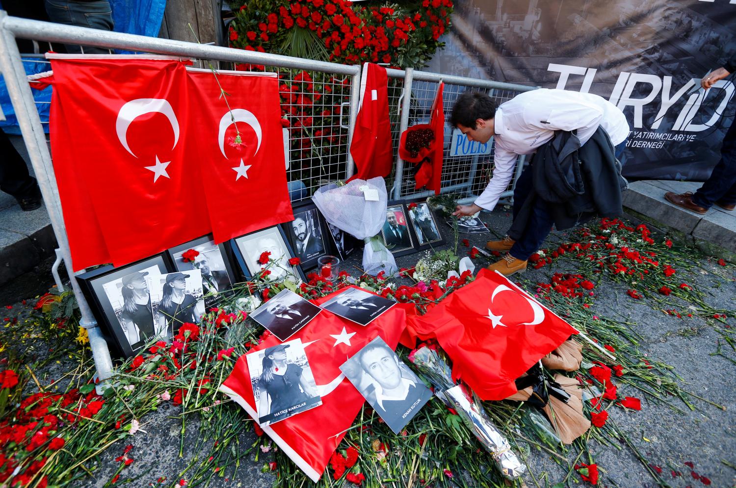 A man places flowers at the entrance of Reina nightclub, which was attacked by a gunman, in Istanbul, Turkey January 3, 2017. REUTERS/Murad Sezer TPX IMAGES OF THE DAY - RTX2XC66