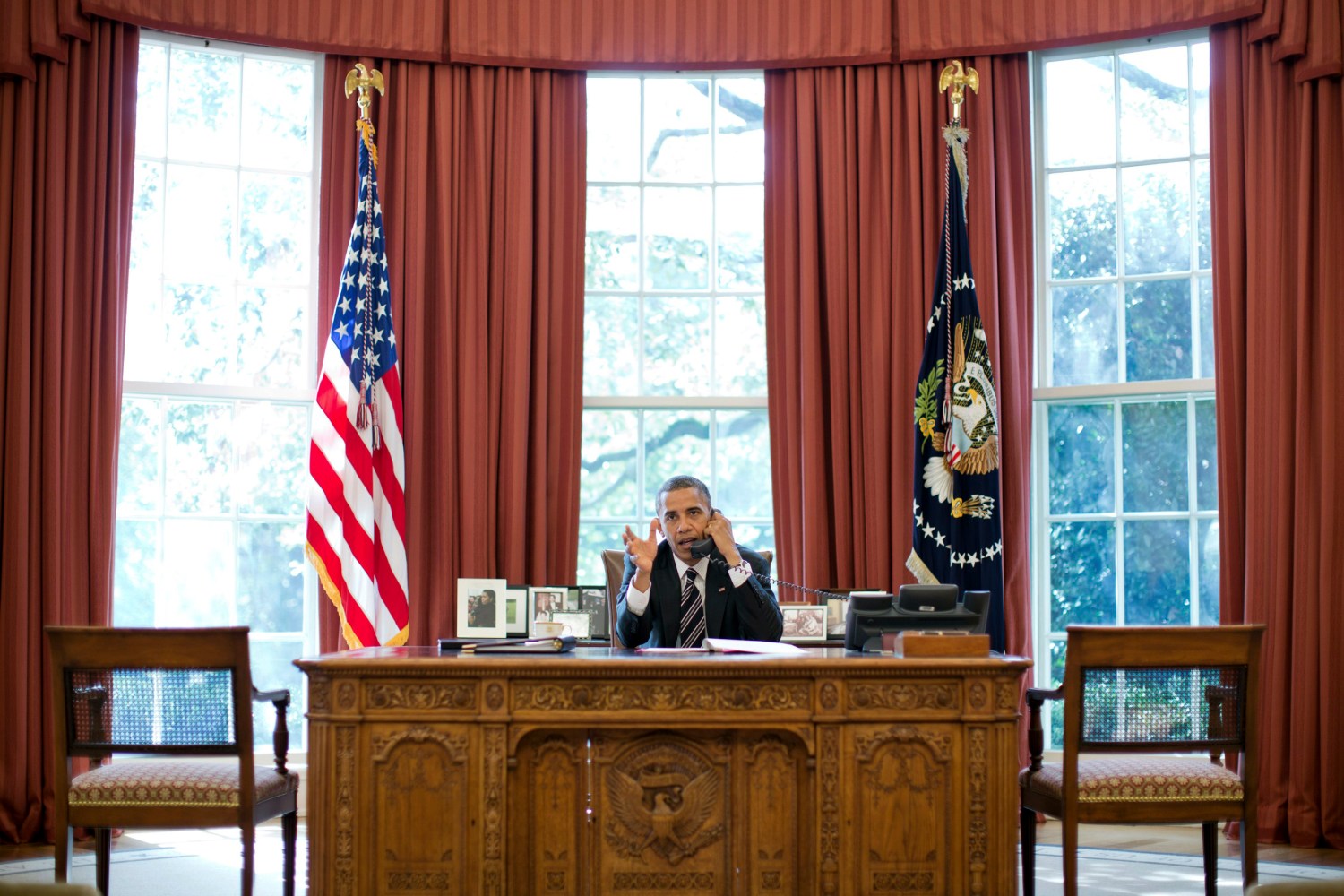 U.S. President Barack Obama speaks on the phone with Israel's Prime Minister Benjamin Netanyahu, in the Oval Office in this September 28, 2012 White House handout photograph. Obama and Netanyahu expressed solidarity on the goal of preventing Iran from acquiring a nuclear weapon, the White House said on Friday, amid signs of easing tensions over their differences on how to confront Tehran.