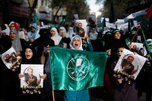 Protesters from the Islamic Action Front, carry pictures of the deputy overall leader of Jordanian Muslim Brotherhood Zaki Bani Rsheid during a demonstration to show their solidarity with Palestinians and anger at the political arrest, after the Friday prayer in Amman November 28, 2014. Rsheid was arrested by the Jordanian authorities last week after he criticized the United Arab Emirates for issuing a list of Islamist organization it considered terrorist groups according to local media.