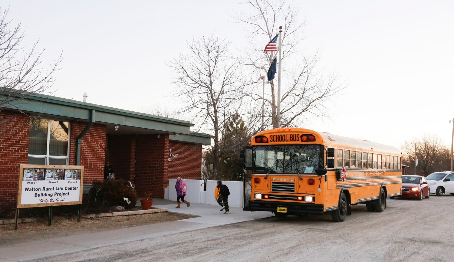 Students arrive at the Walton Rural Life Center Elementary School, in Walton, Kansas, January 18, 2013. Students at the school do farm chores at the beginning of each school day. The Walton Rural Life Center - a kindergarten through fourth grade charter school in rural Kansas - uses agriculture to teach students about math, science, economics. REUTERS/Jeff Tuttle (UNITED STATES - Tags: EDUCATION AGRICULTURE SOCIETY) - RTR3DVPU
