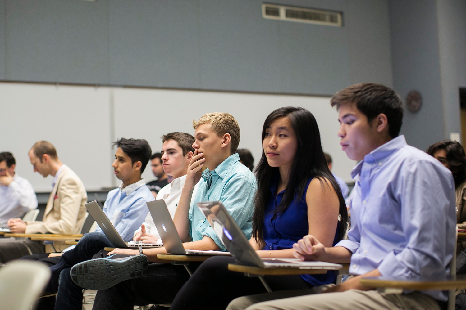 Stanford University students listen while classmates make a presentation to a group of visiting venture capitalists during their Technology Entrepreneurship class in Stanford, California March 11, 2014.