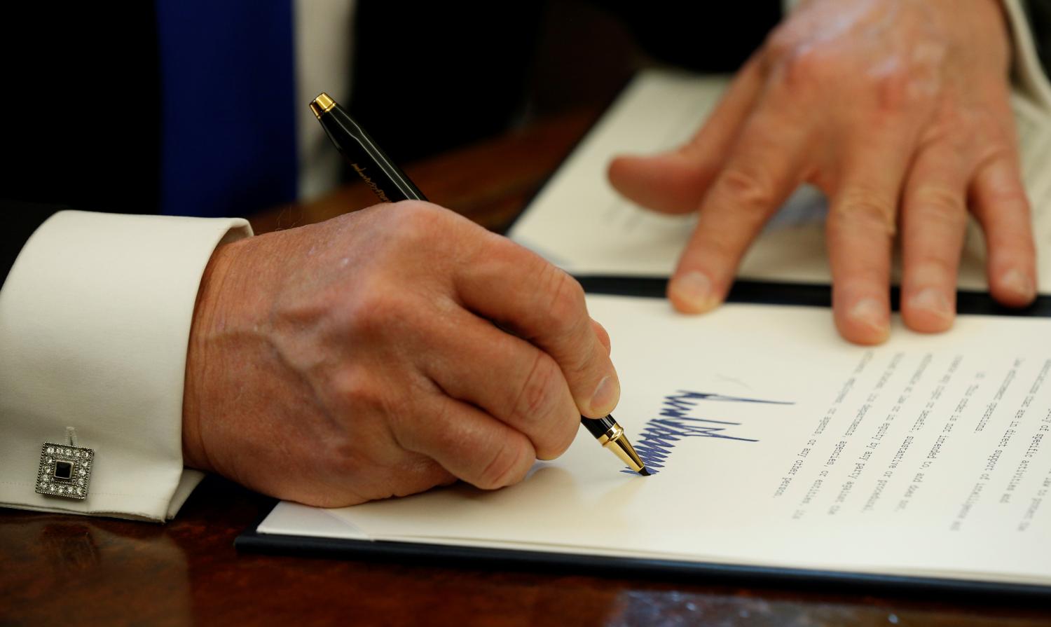 Donald Trump signs an executive order