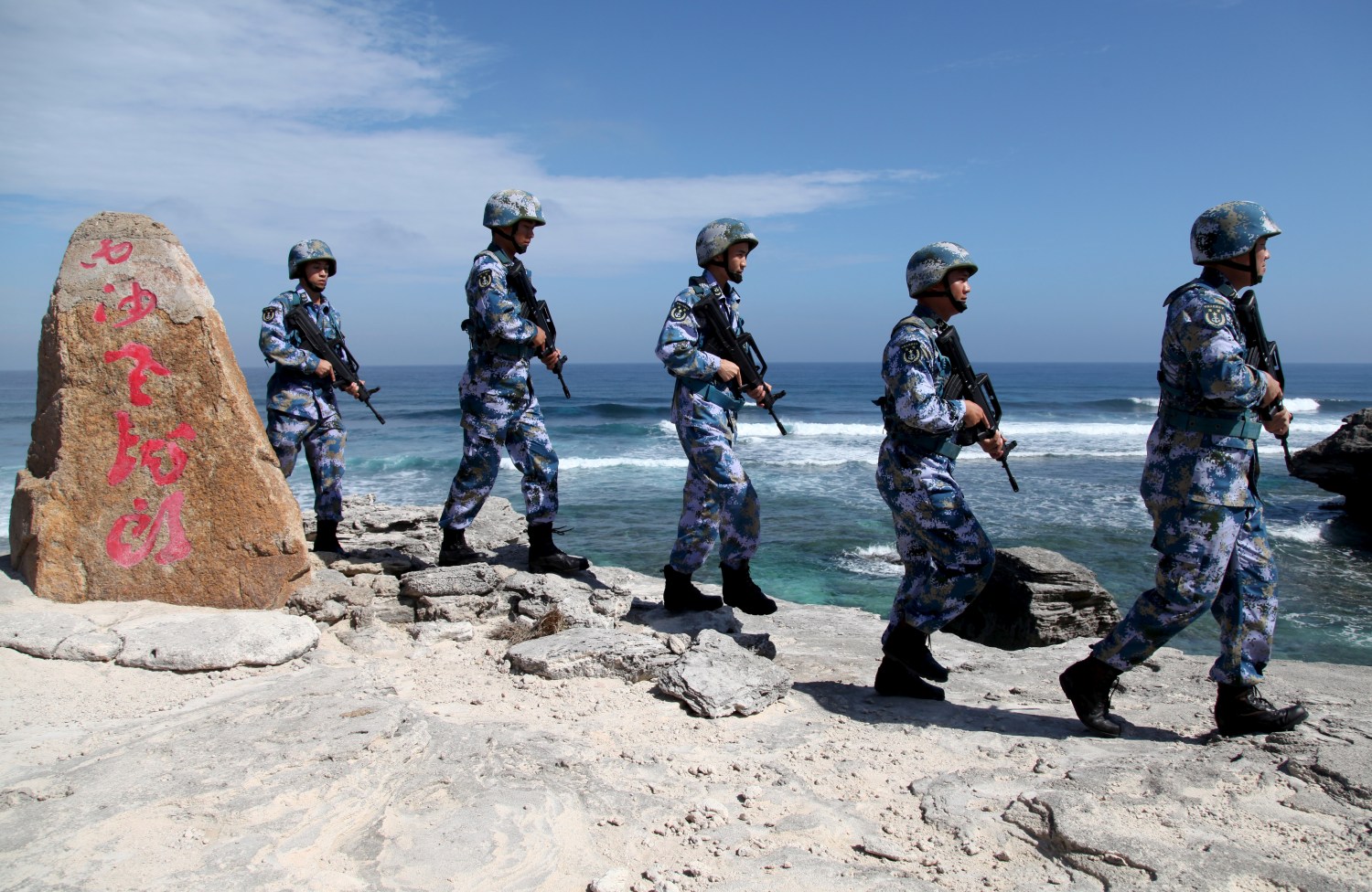 Soldiers of China's People's Liberation Army (PLA) Navy patrol at Woody Island, in the Paracel Archipelago, which is known in China as the Xisha Islands, January 29, 2016. The words on the rock read, "Xisha Old Dragon". Old Dragon is the local name of a pile of rocks near Woody Island. REUTERS/Stringer/File Photo ATTENTION EDITORS - THIS PICTURE WAS PROVIDED BY A THIRD PARTY. THIS PICTURE IS DISTRIBUTED EXACTLY AS RECEIVED BY REUTERS, AS A SERVICE TO CLIENTS. CHINA OUT. NO COMMERCIAL OR EDITORIAL SALES IN CHINA. FROM THE FILES PACKAGE - SEARCH "SOUTH CHINA SEA FILES" FOR ALL IMAGES - RTX2K9DM