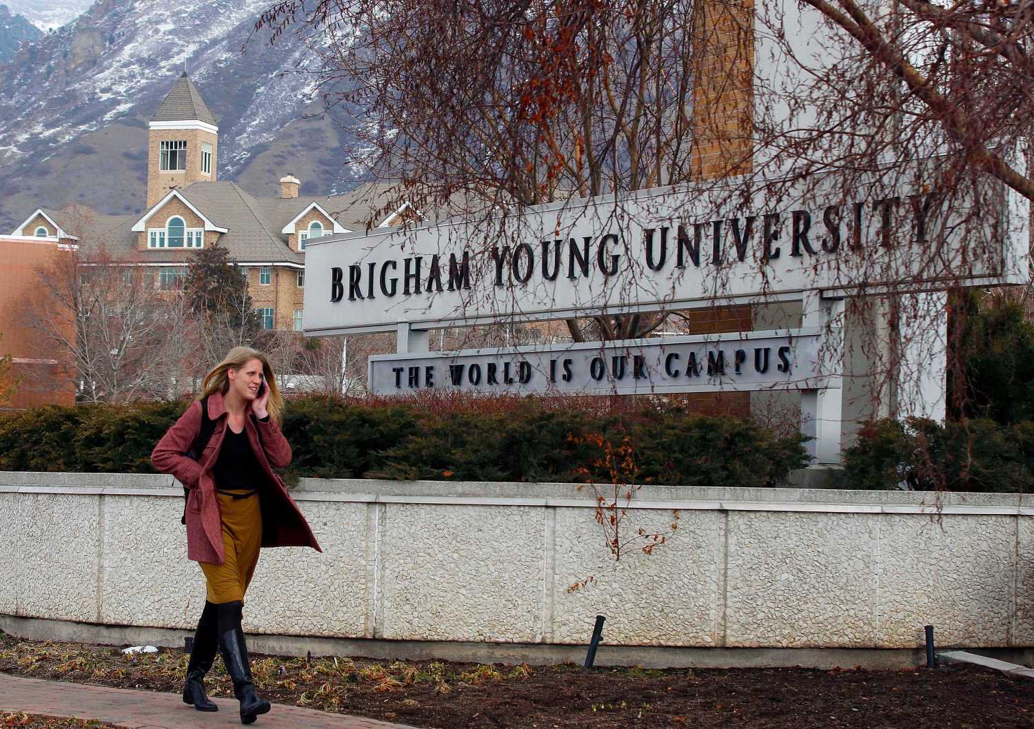 A student walks past the entrance of Brigham Young University in Provo