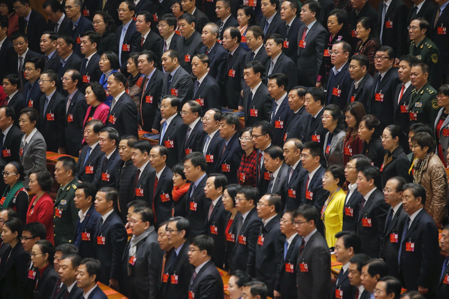 Delegates sing China's national anthem during the closing ceremony of China's National People's Congress at the Great Hall of the People in Beijing