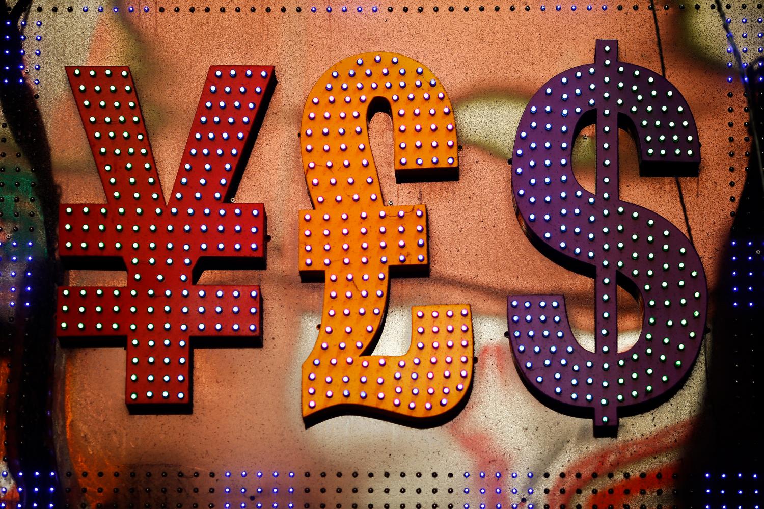 The dollar sign (R) is seen alongside the signs for other currencies above a currency exchange shop in Mongkok shopping district in Hong Kong October 30, 2014. A year-long investigation into allegations of collusion and manipulation by global currency traders is set to come to a head on Wednesday, with Britain's financial regulator and six big banks expected to agree a settlement involving around ?1.5 billion ($2.38 billion) in fines. The settlement comes amid a revival of long-dormant volatility on the foreign exchanges, where a steady rise of U.S. dollar this year has depressed oil prices and the currencies of many commodity exporters such as Russia's rouble, Brazil's real and Nigeria's naira - setting the scene for more turbulence on world financial markets in 2015. Picture taken October 30, 2014. REUTERS/Damir Sagolj (CHINA - Tags: BUSINESS CRIME LAW POLITICS) ATTENTION EDITORS: PICTURE 02 OF 23 FOR WIDER IMAGE PACKAGE 'ANOTHER DAY ANOTHER DOLLAR' TO FIND ALL IMAGES SEARCH 'CURRENCY TRADERS' - RTR4DSZN