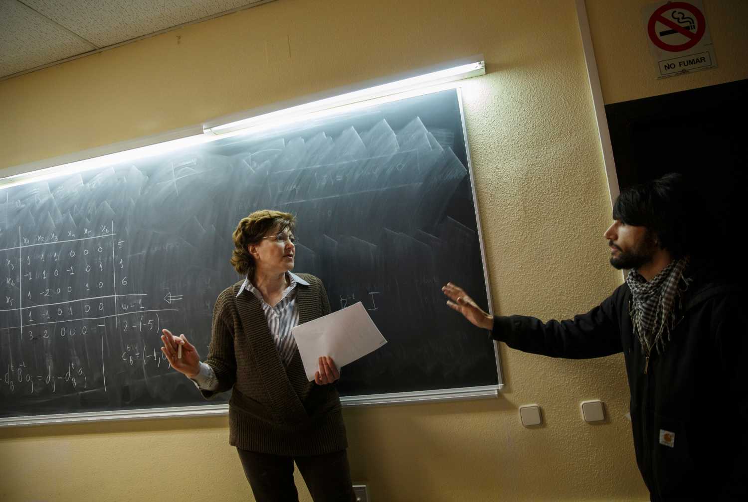 A professor tries to stop striking students from disrupting her class at Complutense University on the second day of a 48-hour student strike to protest against rising fees and educational cuts in Madrid March 27, 2014.