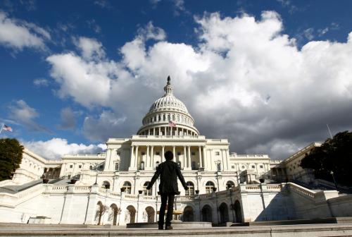 A tourist gazes up towards the dome of the U.S. Capitol.