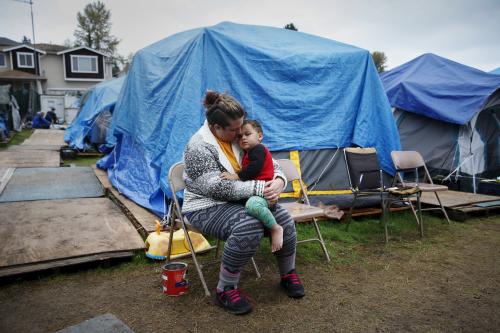 Kadee Ingram, 28, holds her son Sean, 2, at SHARE/WHEEL Tent City 3 outside Seattle, Washington courtesy of Reuters/Shannon Stapleton