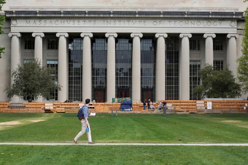 A man walks through Killian Court at MIT.