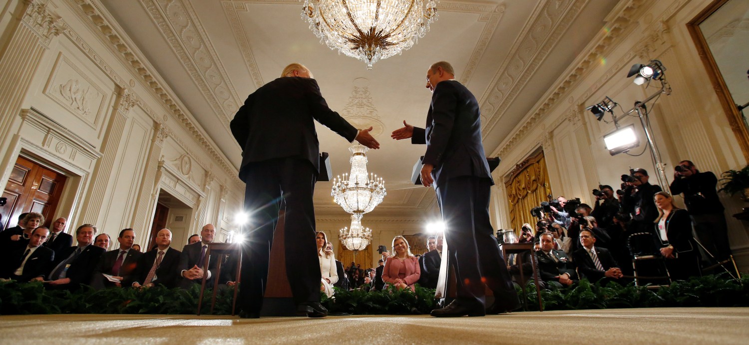 Israeli PM Benjamin Netanyahu shakes hands with U.S. President Donald Trump during a news conference at the White House in Washington, U.S.