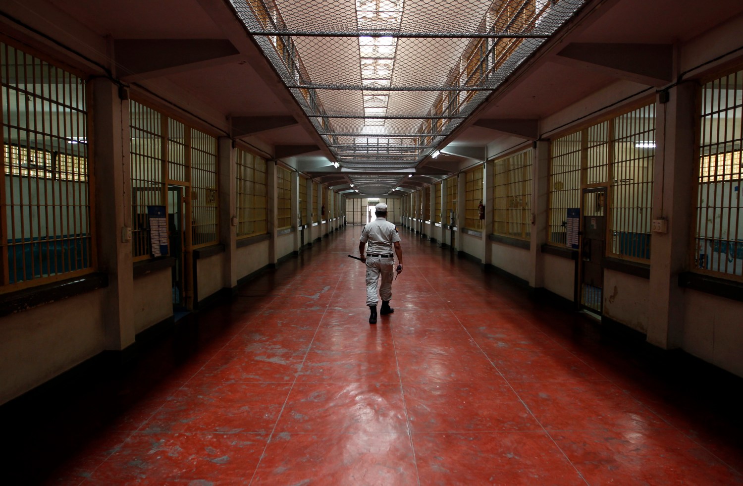 A security guard walks the hall of a prison