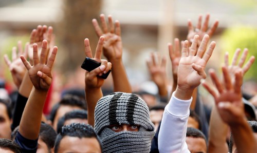 Cairo University students shout slogans against the government and flash the 'V' and Rabaa signs after the verdict of former Egyptian President Hosni Mubarak's trial, at the university's campus in Giza, on the outskirts of Cairo, Egypt, November 30, 2014. To match Special Report EGYPT-STUDENTS/ REUTERS/Staff/File Photo - RTX2F3NV