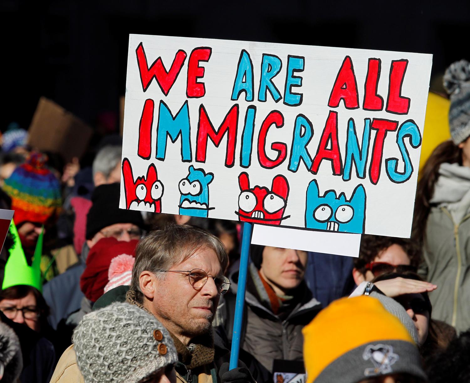 A demonstrator holds a sign to protest against U.S President Donald Trump's executive order banning refugees and immigrants from seven primarily Muslim countries from entering the United States during a rally in Philadelphia, Pennsylvania, U.S.