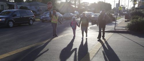Parents walk their children to the campus of Beethoven Street Elementary School in Los Angeles, California