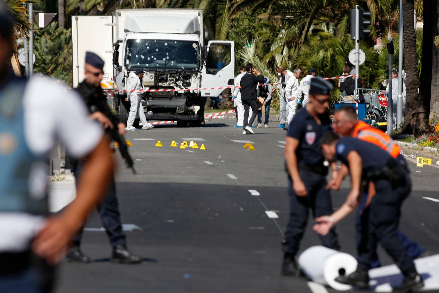 French police secure the area as the investigation continues at the scene near the heavy truck that ran into a crowd at high speed killing scores who were celebrating the Bastille Day July 14 national holiday on the Promenade des Anglais in Nice, France, July 15, 2016. REUTERS/Eric Gaillard - RTSI28V